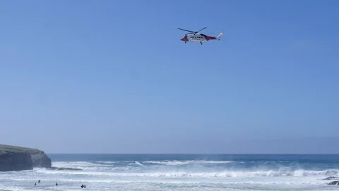 HM Coastguard Helicopter Over The Breaking Waves at a Beach on a Rescue Stock Footage 106555565