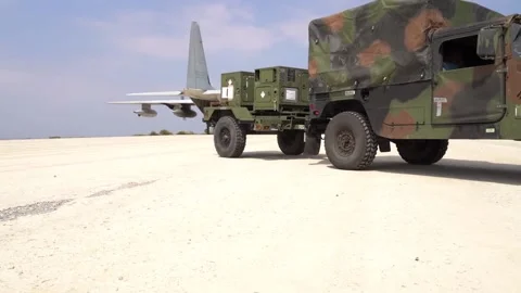 HMARS being driven on dirt runway from C-130 Hercules Vídeos de archivo 150800420