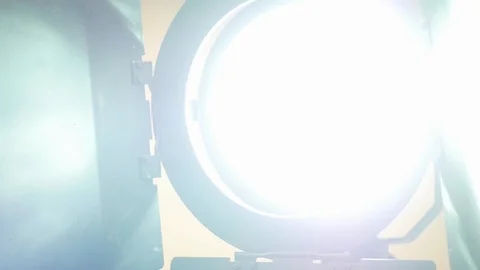An HMI video light powers up, strikes, on the set of a video production shoot. Stock Footage 99427505