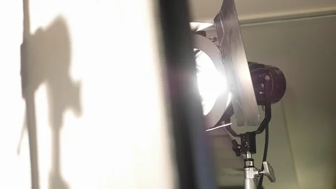 An HMI video light shines through diffusion video production shoot. Stock Footage 99427173