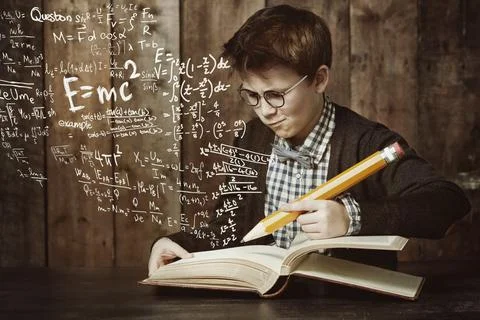 Hmm, this is a tricky problem...a young boy doing his maths homework. Stock Photos