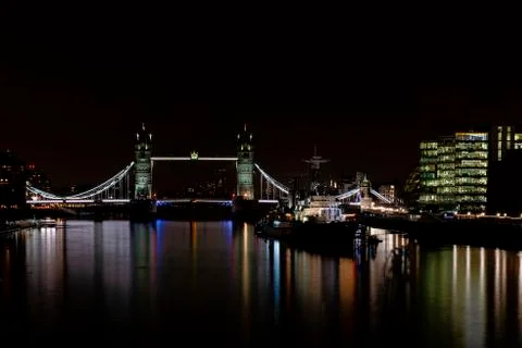 HMS Belfast floating on the river Thames next to Tower Bridge Stock Photos
