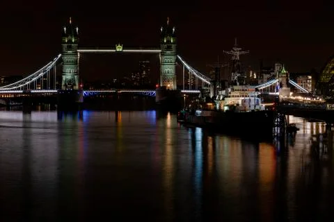 HMS Belfast floating on the river Thames next to Tower Bridge Stock Photos