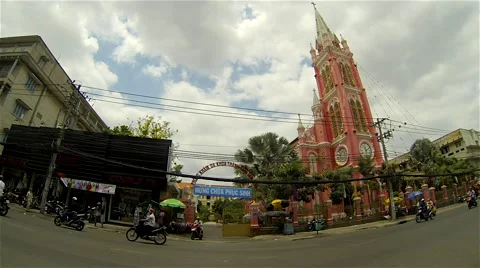 Ho Chi Minh City - April 2015: Street view with traffic in front of church. 4K Stock Footage 49320153