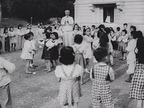 Ho Chi Minh interacts with dancing school children in a film from the 1970s. Stock Footage 75294592