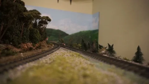 H.O. scale model train operating on a wooded layout 動画素材 97647376