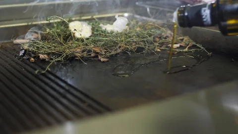 Hob in kitchen of restaurant or cafe, barbecue, pour olive oil. Herbs and spices Stock Footage 88672848