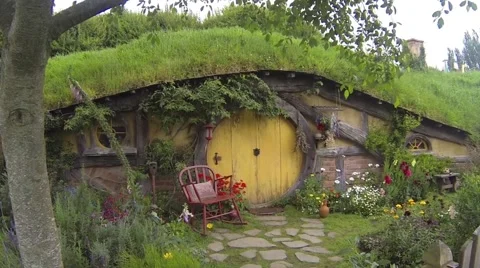 Hobbit hole with yellow door Stock Footage 48126294