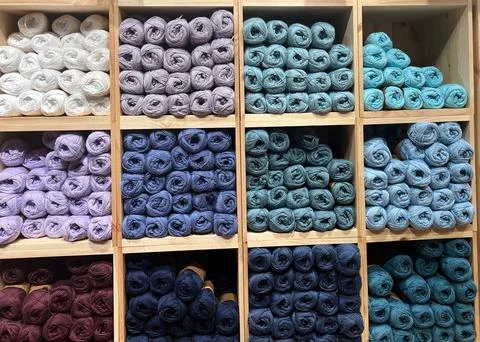 Hobby and knitting concepts. Multi-colored balls of wool on square shelves Stock Photos