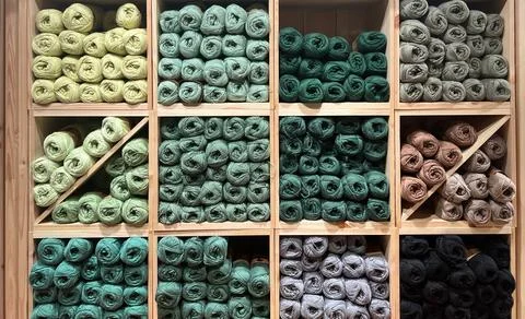 Hobby and knitting concepts. Multi-colored balls of wool on square shelves Stock Photos