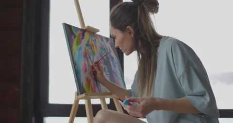 Hobby at home during self-isolation, woman artist is painting picture on canvas Stock Footage 170523044