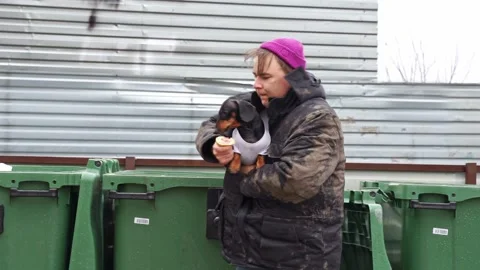 Hobo man, bum in dirty clothes at garbage dump, saves dog abandoned Humanity Video stock 293263403