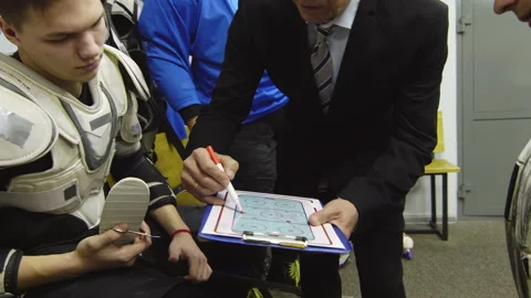 Hockey Coach Explaining Game Tactic to Male Player Stock Footage 147645775