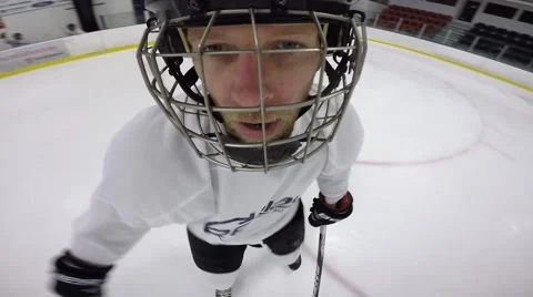 Hockey helmet cam player changes up onto bench Stock Footage 62945012