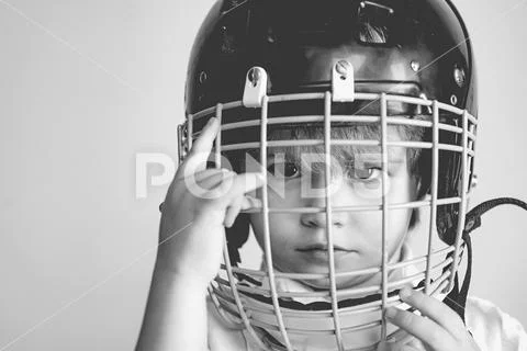 Hockey or rugby helmet. Sport childhood. Future sport star. Sport upbringing and Stock Photos