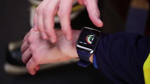 Hockey player changing activity goals on smartwatch before training. Stock Footage 70346064