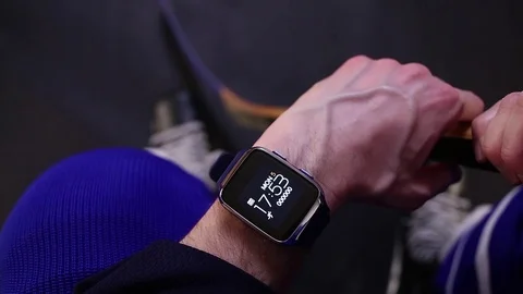 Hockey player checking activity on smartwatch before training. Video stock 70333351