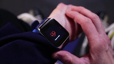 Hockey player checking heart rate on smartwatch before training. Stock Footage 70331534