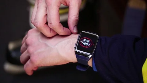 Hockey player checking pulse on smartwatch before training. Stock Footage 70346012