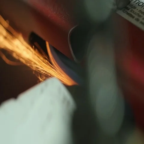 Hockey skate getting sharpened on a machine with sparks Stock Footage 69344637