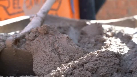 Hoe kneading cement manually by one person. Mixture of cement and sand for .. Stock Footage 242005159
