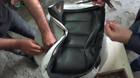 Hog ring attachment secures leather seat - Fasteners Pliers and Workshop Detail Stock Footage 339813637