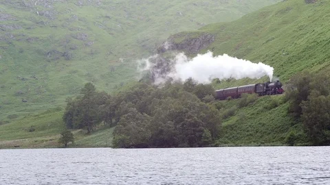 Hogwarts Steam Train in Rugged Scottish Highlands Landscape Stock Footage 84663992