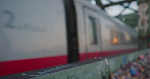 Hohenzollern bridge covered with lovers locks. Train passing on the Hohenzollern Stock Footage 250362353
