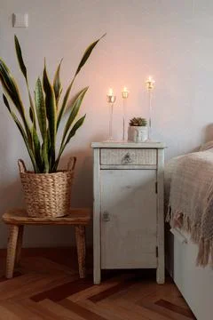 Hohome interior in boho chic style, a beautiful vintage white bedside table, a Stock Photos