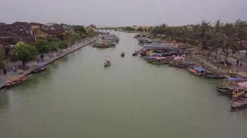 Hoi An river landscape people row boats along channel Stock Footage 164823548