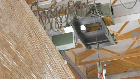 Hoist crane passing on ceiling of factory hall, hoisted board in truck trailer. Stock Footage 99260080