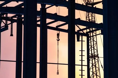 Hoisting hooks hang on the pipes. The object of construction is Foto stock