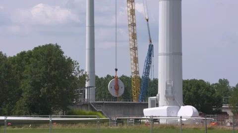 Hoisting a part of a wind turbine using a lattice boom crawler crane Stock Footage 245192195