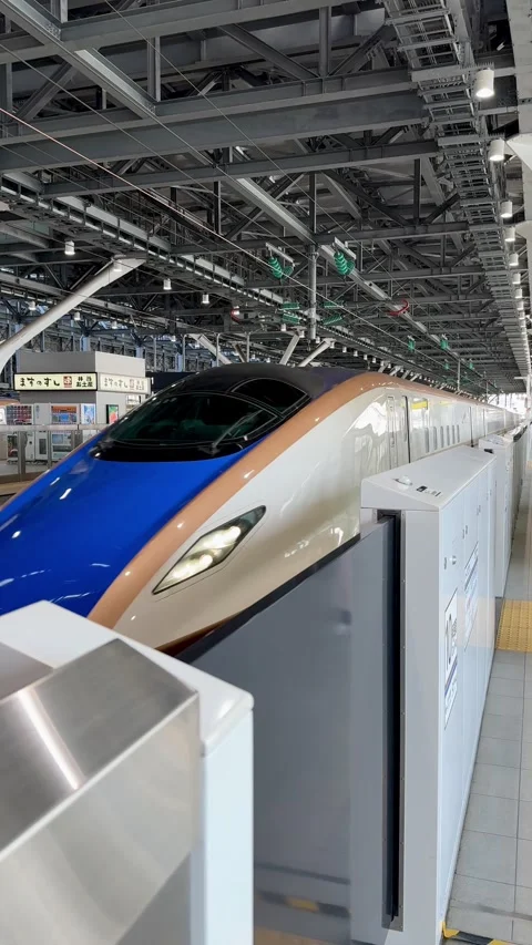 The Hokuriku Shinkansen pulls into the platform at Toyama Station Stock Footage 277954375