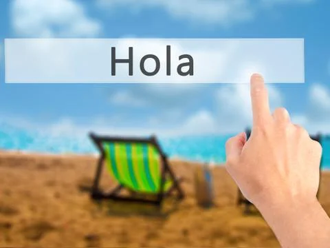 Hola - Hand pressing a button on blurred background concept on visual screen. Stock Photos