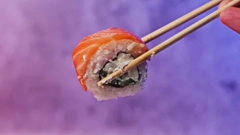 Hold and Take Away One Sushi Roll Using Sticks For Sushi, Close-Up Stock Footage 253387625