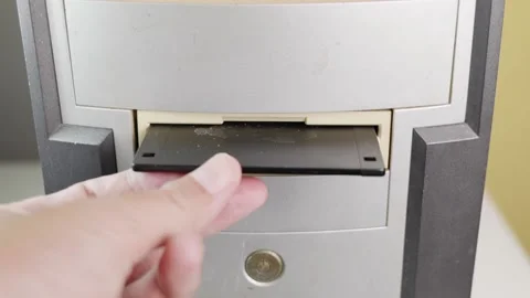 Hold the Floppy A disc and insert the reader. to read and write data It's tec Stock-Footage 196262366