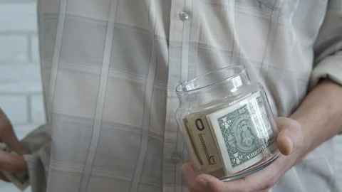 Hold a jar with money. Stock Footage 130144341