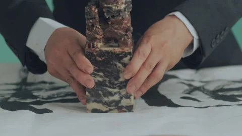 Hold the seal with both hands and place it on rice paper Video stock 140139233