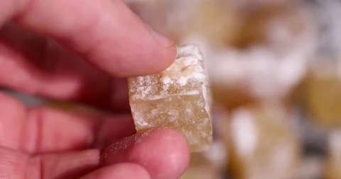 Hold a soft and fresh Turkish delight sprinkled with a small amount of powdered Stock Footage 328098514