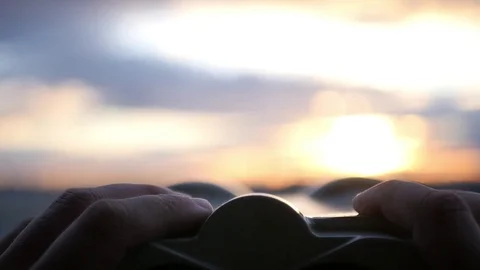 Hold the telescope with your hands, close-up, against the background of the Stock Footage 78963537