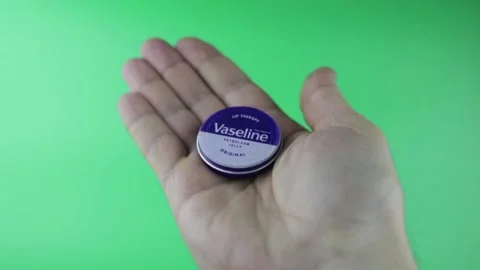 Hold the vaseline, on the green background Stock Footage 150596707