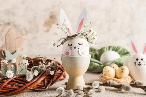 Holder of creative Easter eggs with wreath, pussy willow branches and flowers Stock Photos