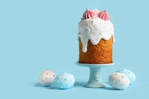 Holder with sweet Easter cake and painted eggs on blue background Stock Photos
