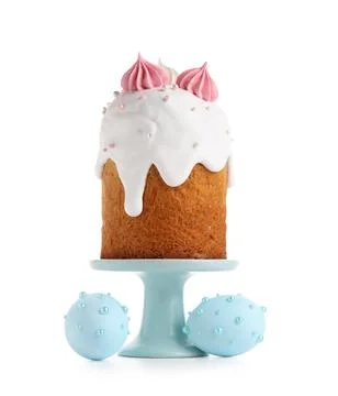 Holder with sweet Easter cake and painted eggs on white background Stock Photos