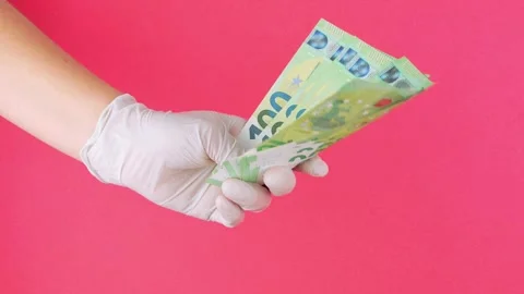 Holding and counting a stack of one hundred banknotes in hands. Person coun.. Stock Footage 265887415