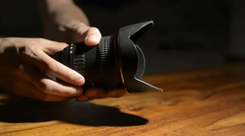 Holding and demonstrating a DSLR  camera lens Stock Footage 48661562