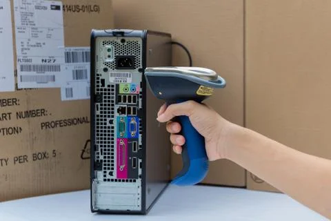 Holding and scanning label on the computer with bluetooth barcode scanner 写真素材