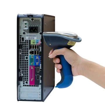 Holding and scanning label on the computer with wireless barcode scanner Foto stock