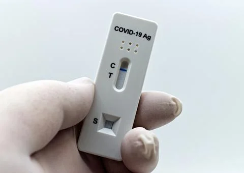 Holding an antigen rapid test device for Covid-19 test. Stock Photos